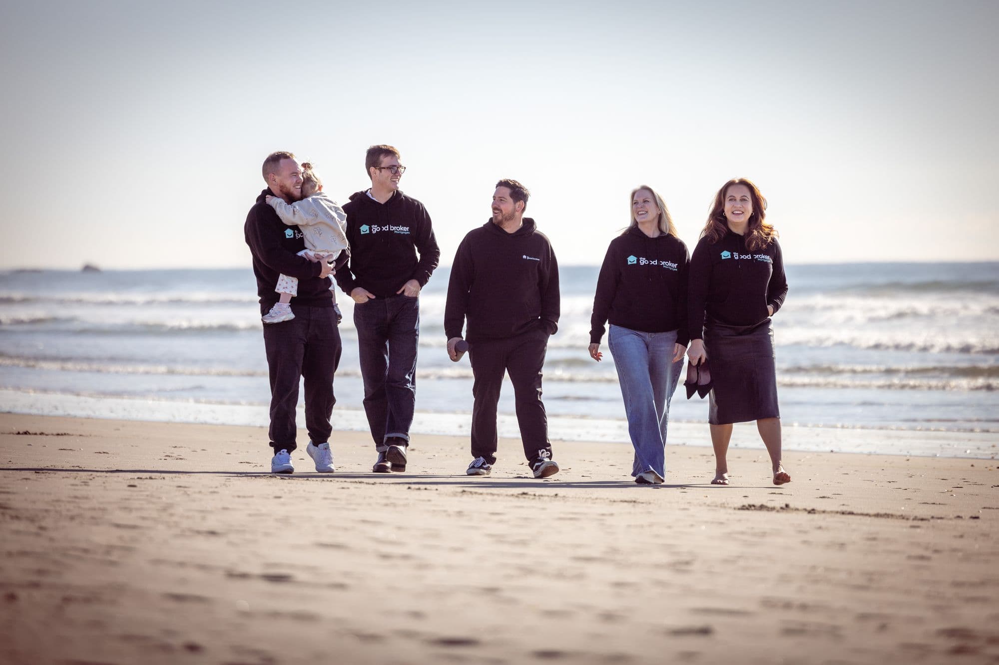 The Good Broker team walking on the beach at Mount Maunganui